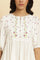 White Peplum Top With Embroidered Yoke