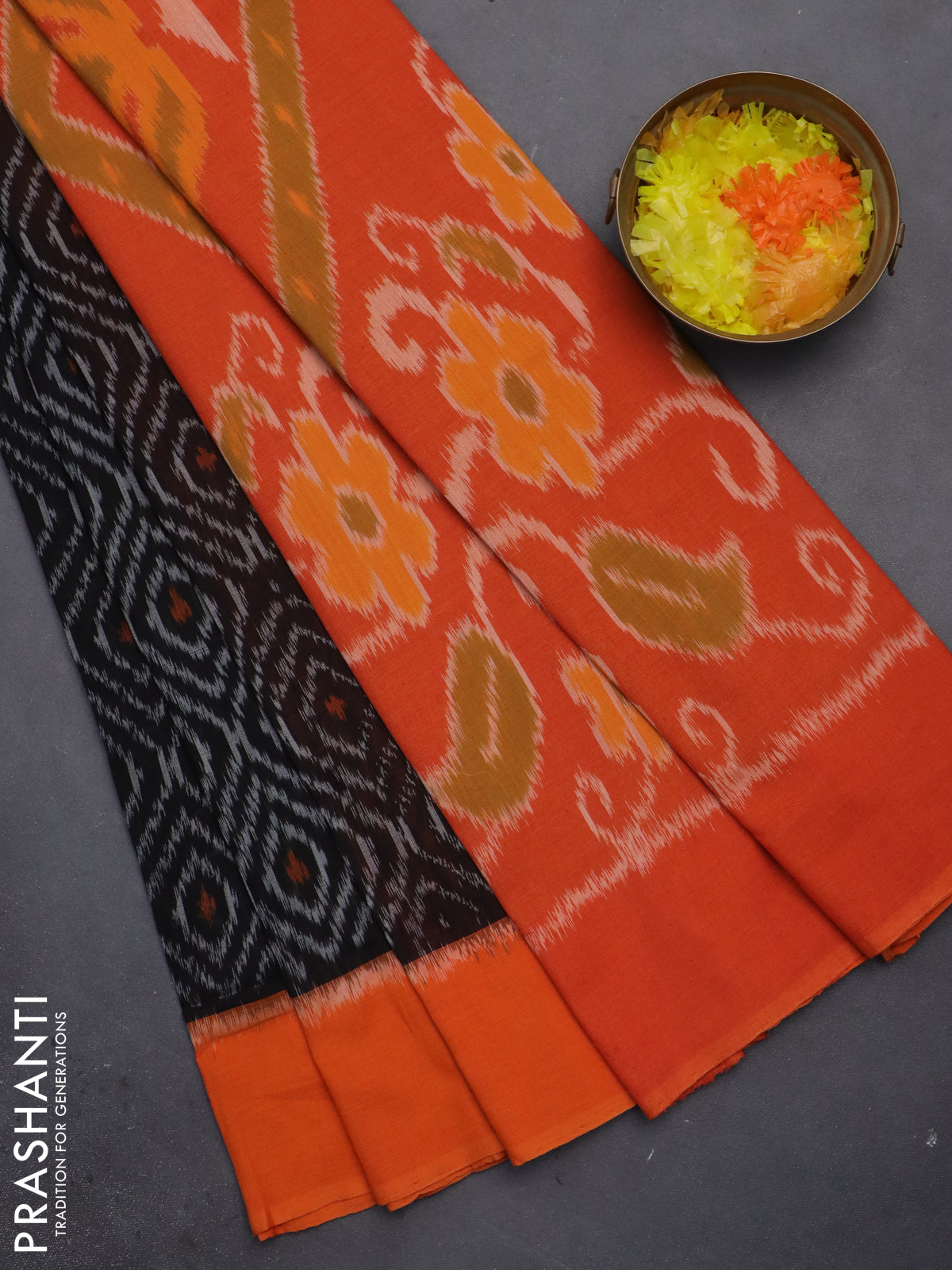 Ikat cotton saree black and orange with allover ikat weaves and simple border