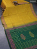 Silk cotton block printed saree dark mustard and green with allover prints and printed border