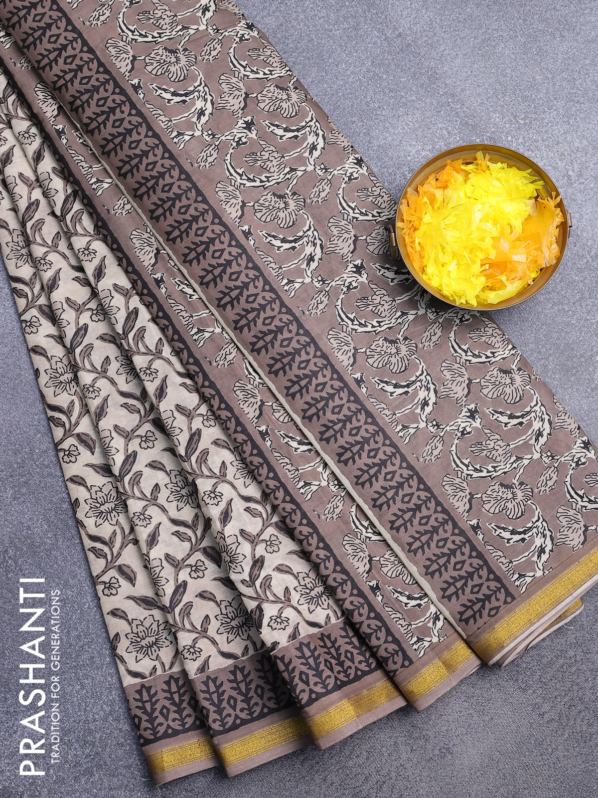 Muslin cotton saree cream and brown shade with allover floral prints and zari woven border