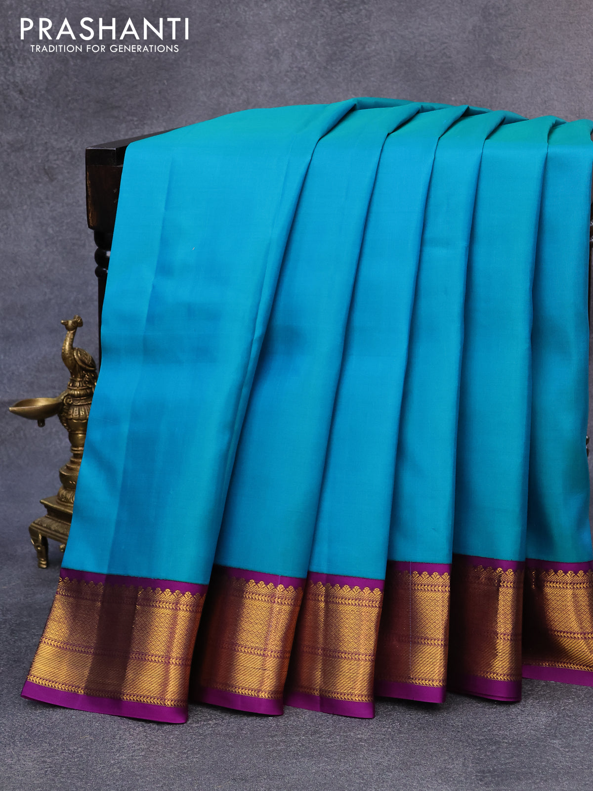 Pure kanjivaram silk saree teal blue and purple with plain body and zari woven korvai border
