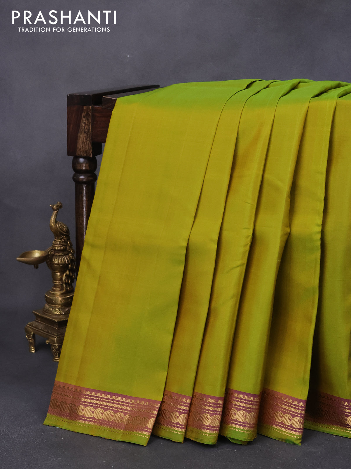 Pure kanjivaram silk saree dual shade of lime green and dual shade of violet with plain body and paisley zari woven border