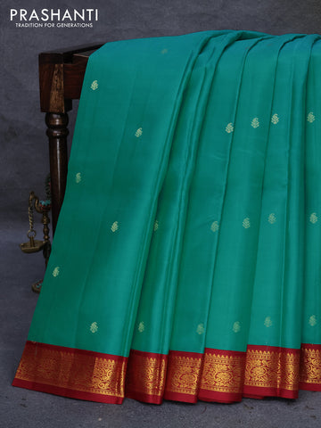 Pure kanjivaram silk saree dual shade of teal blue and maroon with paisley zari woven buttas and zari woven korvai border