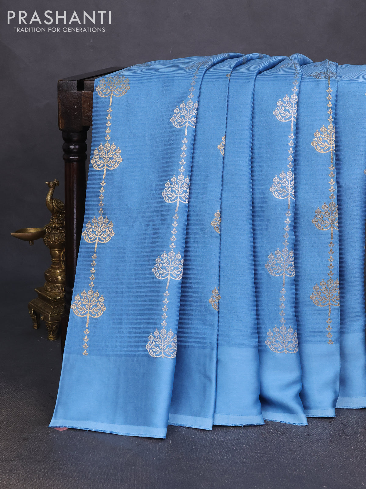 Banarasi mushru silk saree light blue with allover stripes pattern & zari buttas and satin border