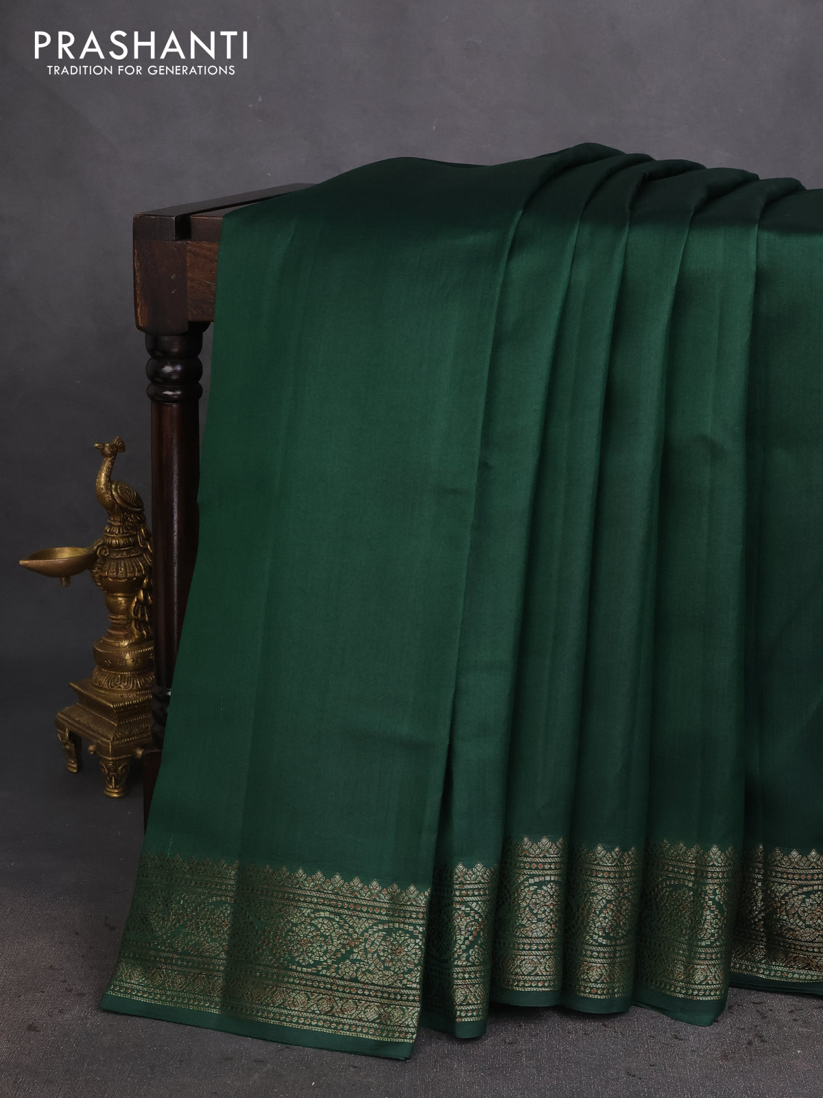 Chiniya silk saree dark green and rust shade with plain body and woven border