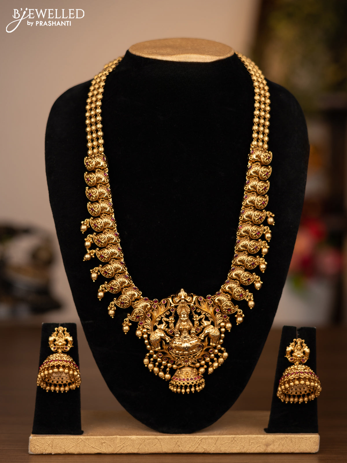 Antique haaram lakshmi design with pink kemp stones and golden beads hanging