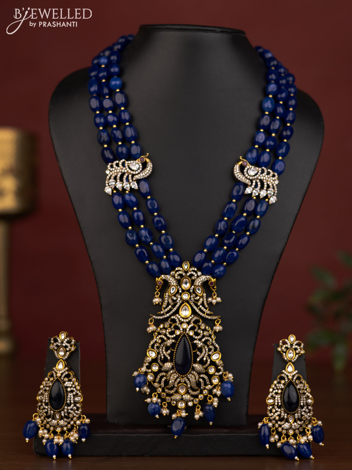 Beaded triple layer blue necklace peacock pendant with ruby & cz stones and beads hanging in victorian finish