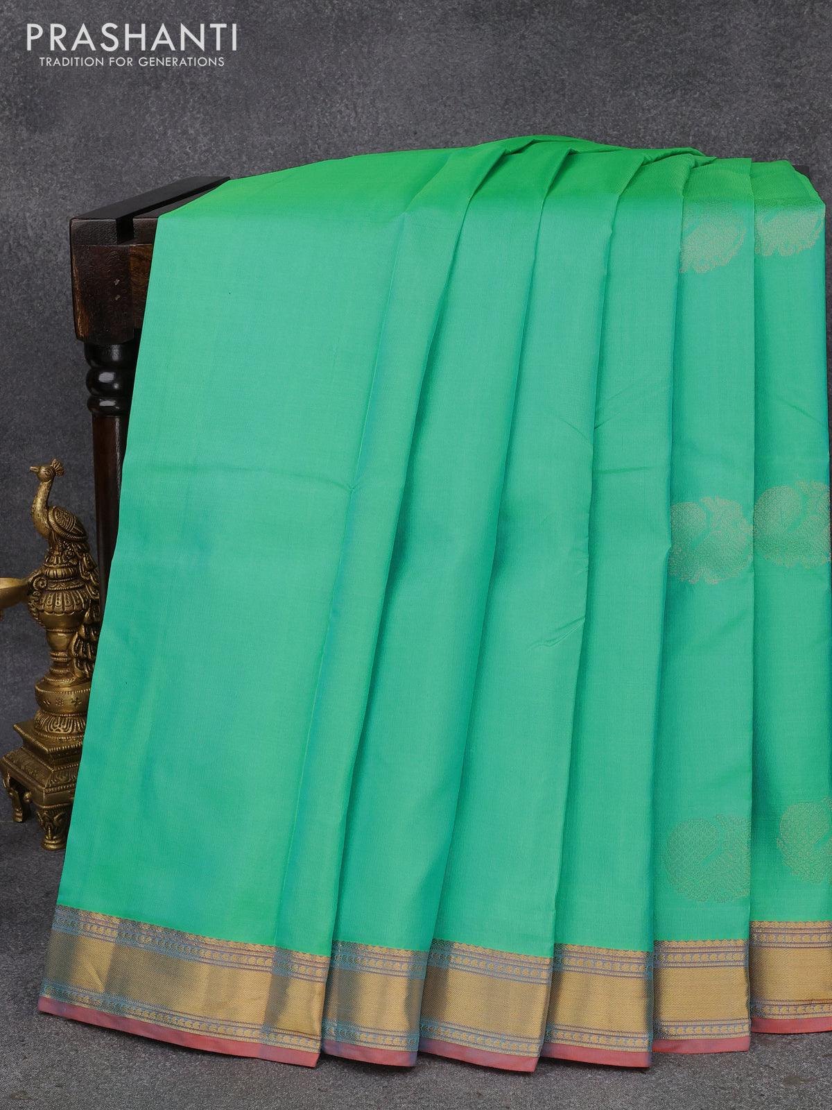 Pure kanjivaram silk saree dual shade of teal bluish green and dual shade of pinkish orange with annam zari woven buttas and zari woven border