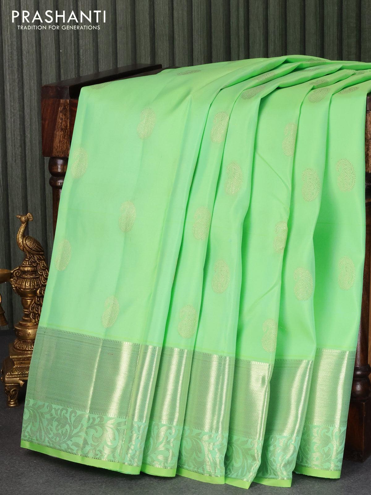 Pure kanjivaram silk saree green shade with silver zari woven paisley buttas and silver zari woven border